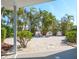 Backyard featuring a patio area overlooking a beautifully landscaped area with palm trees at 4550 Plaza Way, St Pete Beach, FL 33706