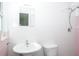 A cozy bathroom features a pedestal sink, toilet, and a tiled shower with shower head at 4550 Plaza Way, St Pete Beach, FL 33706