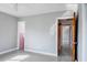 This bedroom features neutral paint, a window with natural light and an open doorway to another room at 4550 Plaza Way, St Pete Beach, FL 33706