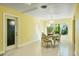 Inviting dining area with yellow walls and access to the outdoors at 4550 Plaza Way, St Pete Beach, FL 33706