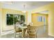 Dining room with yellow walls, tile floors, and a large window with tropical views at 4550 Plaza Way, St Pete Beach, FL 33706