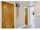 Hallway with light-colored walls and floors, featuring a decorative wall chime, and multiple doorways at 4550 Plaza Way, St Pete Beach, FL 33706