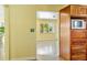 Open concept kitchen and hallway area featuring natural wood and stone countertop at 4550 Plaza Way, St Pete Beach, FL 33706
