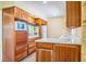 Open concept kitchen with natural wood cabinets, drawers, and stone countertop at 4550 Plaza Way, St Pete Beach, FL 33706