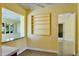Room featuring built-in shelving and peek-through to kitchen with countertops and natural light at 4550 Plaza Way, St Pete Beach, FL 33706