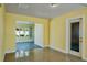 Bright living room with yellow walls, terrazzo floors, and an abundance of natural light at 4550 Plaza Way, St Pete Beach, FL 33706