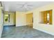 Open-concept room with tile floors, light walls, ceiling fan, and plentiful natural light at 4550 Plaza Way, St Pete Beach, FL 33706
