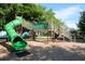 Playground at Lido Park with a green slide, climbing structures, and a wood chip surface at 4550 Plaza Way, St Pete Beach, FL 33706
