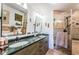 Bathroom with double sink vanity, a glass enclosed shower, and separate toilet room at 4937 Dover Ne St, St Petersburg, FL 33703