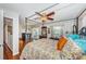 Well-lit bedroom with hardwood floors, a canopy bed, and private terrace access at 4937 Dover Ne St, St Petersburg, FL 33703