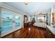 Well-lit bedroom with hardwood floors, a canopy bed, and a view of the water at 4937 Dover Ne St, St Petersburg, FL 33703
