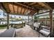 Outdoor patio with canal view, wooden pergola, built-in grill, and swing offering a relaxed waterfront living experience at 4937 Dover Ne St, St Petersburg, FL 33703