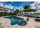Kidney-shaped pool with lush landscaping and canal views offers a relaxing outdoor retreat at 4937 Dover Ne St, St Petersburg, FL 33703