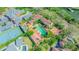 Overhead view shows home and tennis court, surrounded by lush foliage, close to the serene waterfront at 5020 S Shore Crest Cir, Tampa, FL 33609