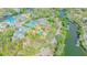 Aerial view shows the estate's proximity to the waterfront, nestled amidst lush greenery in a neighborhood at 5020 S Shore Crest Cir, Tampa, FL 33609