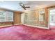Elegant bedroom with floral wallpaper, plush carpet, and a ceiling fan at 5020 S Shore Crest Cir, Tampa, FL 33609