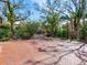 Long driveway paved in red tile leading to a wrought iron gate surrounded by lush landscaping at 5020 S Shore Crest Cir, Tampa, FL 33609