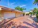 Oversized two-car garage with a brick paver driveway and mature landscaping at 5020 S Shore Crest Cir, Tampa, FL 33609