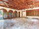 Expansive living area featuring wood paneled ceiling, tile flooring, and large arched windows at 5020 S Shore Crest Cir, Tampa, FL 33609