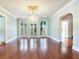 Elegant living room featuring hardwood floors, chandelier, and graceful archway at 5020 S Shore Crest Cir, Tampa, FL 33609