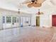 Unfinished room with terracotta tiled floors, French doors, and multiple ceiling fans at 5020 S Shore Crest Cir, Tampa, FL 33609