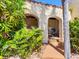 Outdoor space featuring arched openings, lush greenery, and a wooden walkway at 5020 S Shore Crest Cir, Tampa, FL 33609