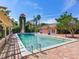 Large pool surrounded by brick pavers, a tower, and a pool house at 5020 S Shore Crest Cir, Tampa, FL 33609