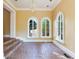 Sunroom with brick floor, chandelier, and white framed arched windows looking out at the lush yard at 5020 S Shore Crest Cir, Tampa, FL 33609