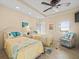 Charming bedroom with twin beds, coastal decor, and a ceiling fan at 5301 Gulf Blvd # F609, St Pete Beach, FL 33706