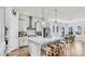 Bright, modern kitchen featuring a large island with seating, stainless steel appliances, and modern lighting at 5317 Del Coronado Dr, Apollo Beach, FL 33572