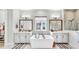 Modern main bathroom with dual sinks, and a standalone soaking tub, with generous natural light at 5317 Del Coronado Dr, Apollo Beach, FL 33572