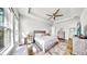 Bright bedroom features a ceiling fan, dresser, and a large window, for comfort and style at 5317 Del Coronado Dr, Apollo Beach, FL 33572