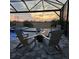 Outdoor patio with fire pit, chairs and an impressive sunset view for evening relaxation at 5317 Del Coronado Dr, Apollo Beach, FL 33572