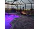 Relaxing pool area with a fire pit, seating, and illuminated pool water at twilight at 5317 Del Coronado Dr, Apollo Beach, FL 33572
