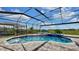 Beautiful screened-in pool with chairs, fountain, and open backyard view perfect for relaxation at 5317 Del Coronado Dr, Apollo Beach, FL 33572
