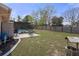Spacious backyard featuring a grill, patio set, and fence, perfect for outdoor activities at 5357 Kirkwood Ave, Spring Hill, FL 34608