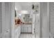 Bright white bathroom with double sinks and linen closet at 5357 Kirkwood Ave, Spring Hill, FL 34608