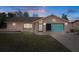 Charming single-story home with a well-maintained lawn, colorful garage door, and welcoming curb appeal at 5357 Kirkwood Ave, Spring Hill, FL 34608