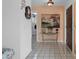 Welcoming foyer with tile flooring, decorative accents, and a view of the laundry room at 5357 Kirkwood Ave, Spring Hill, FL 34608