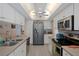 Bright kitchen with white cabinets, stainless steel appliances, and a view of the breakfast bar at 5357 Kirkwood Ave, Spring Hill, FL 34608