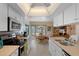 Modern kitchen with stainless steel appliances, white cabinetry, and a breakfast bar overlooking dining area at 5357 Kirkwood Ave, Spring Hill, FL 34608