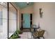 Inviting front porch with a seating area and vibrant blue door, perfect for enjoying the outdoors at 5357 Kirkwood Ave, Spring Hill, FL 34608