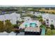 Aerial view of condo community featuring a pool, tennis courts, and beautiful landscaping at 6916 Stonesthrow N Cir # 9103, St Petersburg, FL 33710