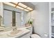 Clean bathroom with a modern vanity, bright lighting, and a mirrored wall at 6916 Stonesthrow N Cir # 9103, St Petersburg, FL 33710
