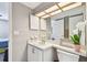 Bright bathroom with white vanity, mirrored cabinet, and decorative lighting, next to the bedroom at 6916 Stonesthrow N Cir # 9103, St Petersburg, FL 33710