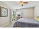 Bedroom featuring a sliding glass door with pond view, ceiling fan, and a cozy computer workspace at 6916 Stonesthrow N Cir # 9103, St Petersburg, FL 33710
