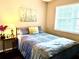 Cozy bedroom with a comfortable bed, bedside table, and a large window at 6916 Stonesthrow N Cir # 9103, St Petersburg, FL 33710