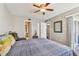 Bedroom features ceiling fan, ensuite bathroom, and comfortable setting, promoting relaxation and convenience at 6916 Stonesthrow N Cir # 9103, St Petersburg, FL 33710