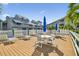 Condo deck featuring several tables, chairs, umbrellas, and lounge seating at 6916 Stonesthrow N Cir # 9103, St Petersburg, FL 33710