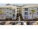 Exterior of condo complex with multiple levels, lush landscaping, and parking at 6916 Stonesthrow N Cir # 9103, St Petersburg, FL 33710